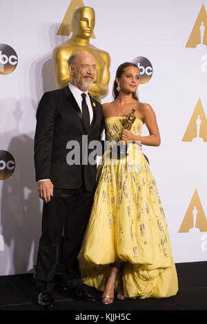 HOLLYWOOD, CA - FEBRUARY 28: J.K. Simmons, Alicia Vikander in the press room during the 88th Annual Academy Awards at Loews Hollywood Hotel on February 28, 2016 in Hollywood, California.   People:  J.K. Simmons, Alicia Vikander Stock Photo