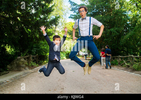 Newlyweds jumping with a boy. France. Stock Photo