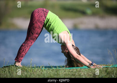 Woman doing yoga and meditation outside. Stock Photo
