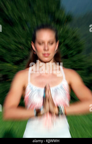 Blurred Motion Of Young Woman Practicing Yoga.  France. Stock Photo