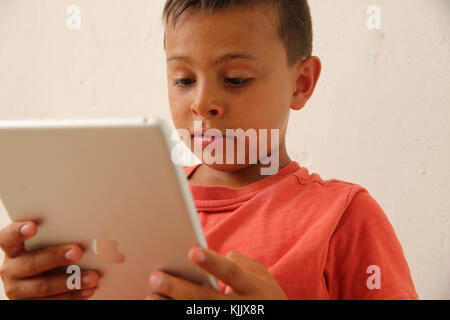 Boy using a digital tablet. Stock Photo