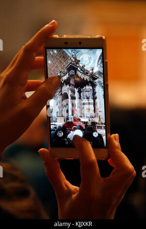Visitor taking a cell phone picture in St Peter's basilica, Rome. Italy. Stock Photo