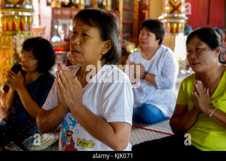 Buddhist faithful praying in a Yang Nuen pagoda. Thailand. Stock Photo