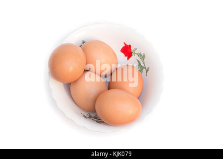five eggs in Cup. Isolated on white background Stock Photo