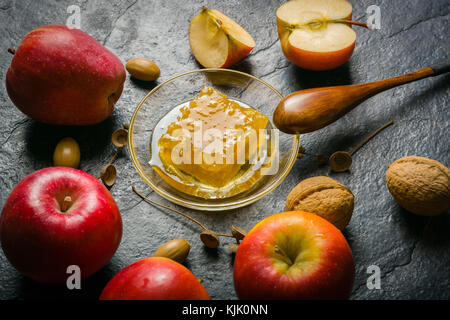 Homemade nice background of autumn apples, honey and walnuts. Black stone background. View from above. place for text. Copy space. Stock Photo