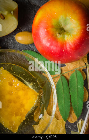 Homemade nice background of autumn apples, honey and walnuts. Black stone background. View from above. place for text. Copy space. Stock Photo