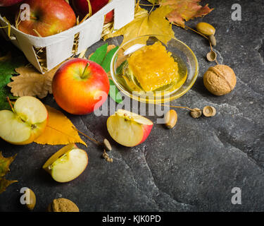 Homemade nice background of autumn apples, honey and walnuts. Black stone background. View from above. place for text. Copy space. Stock Photo
