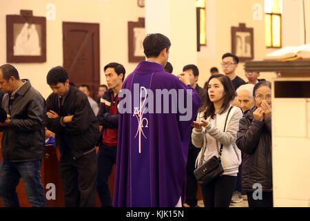 Dalat cathedral.  Catholic mass.  Catholic priest giving Holy Communion.  Dalat. Vietnam. Stock Photo