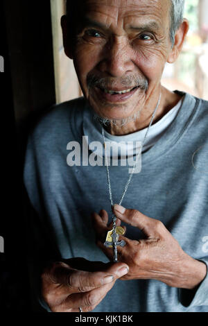 Old catholic man with a crucifix in hands.  Kon Tum.  Vietnam. Stock Photo