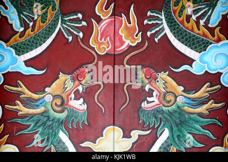 Chua Ong buddhist Pagoda. Ornate temple door with two dragons.  Hoi An. Vietnam. Stock Photo
