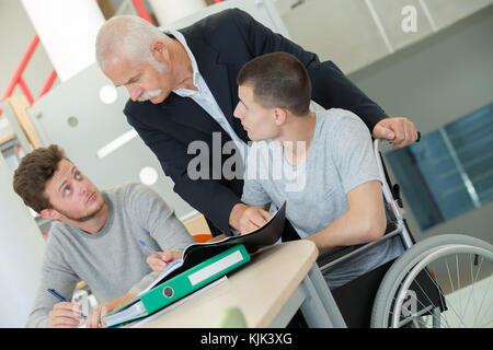 man lecturing students in a university lecture theatre Stock Photo