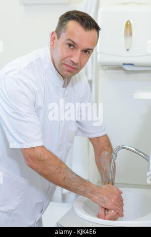 Portrait of doctor washing hands Stock Photo