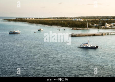 Catamaran and small fishing boats moored at Grand Cayman Stock Photo