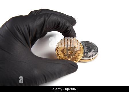 Male hand in black glove holds bitcoin isolated on white. Crime and cryptocurrency concept Stock Photo