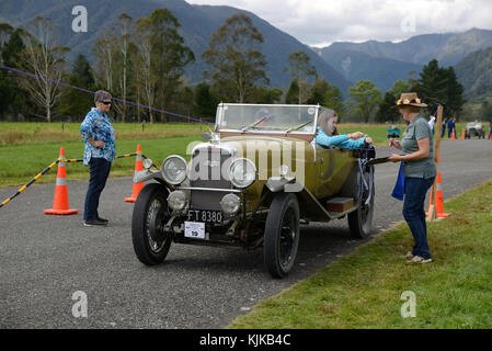 HAUPIRI, NEW ZEALAND, MARCH 18, 2017: Contestants in a vintage car rally hang out washing in a timed competition. The vehicle is a 1930 Alvis Silver S Stock Photo