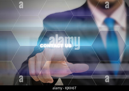 Businessman touching the Contact us icon on the Abstract blurred photo background, Business customer service concept Stock Photo