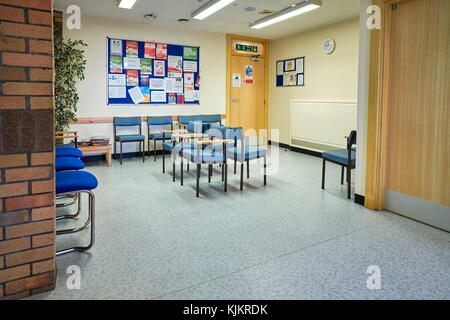 Doctors waiting room with chairs and notices Stock Photo