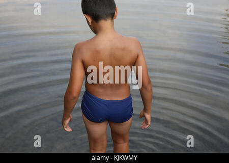 Boy wading in a river. France. Stock Photo