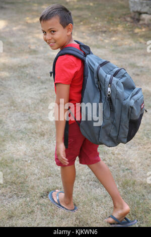 Boy carrying a backpack. France. Stock Photo