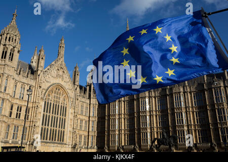 The stars of the EU flag fly over the Houses of Parliament in Westminster, seat of government and power of the United Kingdom during Brexit negotiations with Brussels, on 23rd November 2017, in London England. Stock Photo