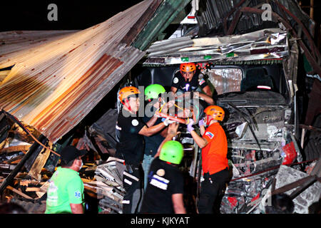 Philippines. 24th Nov, 2017. Rescue team removed one of the two bodies of un-identified ten wheelers truck drivers who collided in a 5 commercial establishment and injured several stay-in employees after the driver out of controls of the heavy vehicle in-front of Maries Village, Marcos Highway in Antipolo City on the evening of November 23, 2017. They also damaged several vehicles on the highway before colliding with a commercial establishment. Credit: Gregorio B. Dantes Jr./Pacific Press/Alamy Live News Stock Photo