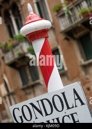 VENICE, ITALY - SEPTEMBER 12, 2017:  Striped Pole with Gondola Service Sign Stock Photo