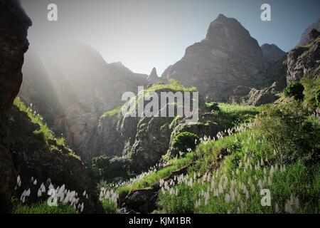 High mountains and picks of santa antao island in cape verde during a sunny day. The sun is lighting the landscape, the rocks and the vegetation. Stock Photo