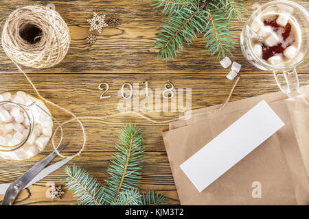 Packing a smartphone for a gift. The mess on the table. Place for text. The view from the top. Dark background, wood Stock Photo