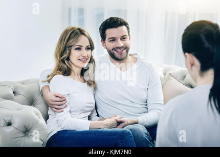 Delighted happy couple being thankful for psychological sessions Stock Photo