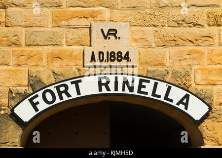 Front access gate with name plaque sign  ' Fort Rinella ' over the main arch entrance door of the home of the ' 100 Ton Gun ' Rinella Battery. Malta. Stock Photo