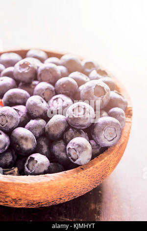 Freshly picked blueberries in wooden bowl,selective focus Stock Photo