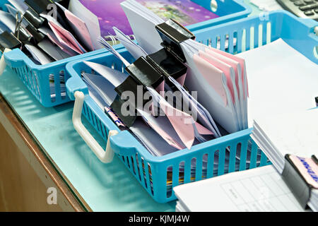Documents with black paper clip in plastic basket Stock Photo