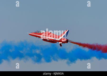 Red Arrows flypast with spoiler deployed red and blue smoke Stock Photo