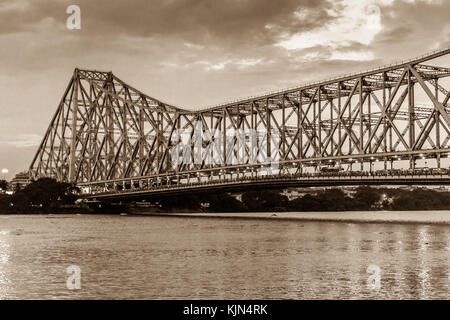 Howrah bridge in sepia color - The historic cantilever bridge on the river Hooghly with moody sky. Stock Photo