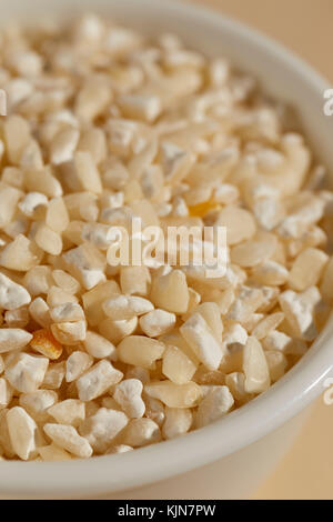 A bowl of dried white hominy, corn, called  maiz trillado or Morocho Partido in Spanish Stock Photo