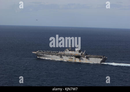 The amphibious assault ship USS Iwo Jima (LHD 7) sails in the Atlantic Ocean during a simulated strait transit exercise as part of Combined Composite  Stock Photo