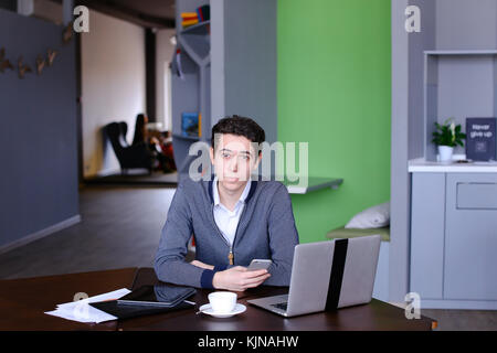 Portrait of smart young guy student who posing and looking in ca Stock Photo