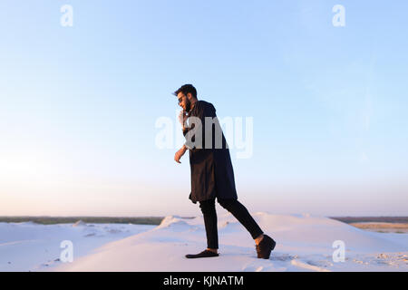 Handsome male Arab businessman talks on cellular business pro, s Stock Photo