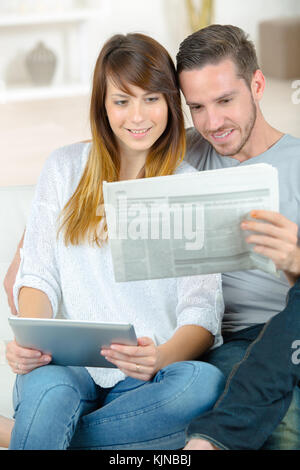 couple reading news from different source Stock Photo