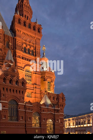 The State Historical Museum building illuminated at night, with upmarket GUM shopping mall in the background, Red Square, Moscow, Russia. Stock Photo