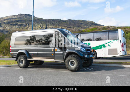 HAUKADALUR, ICELAND - SEPTEMBER 6, 2017: excursion cars in parking lots in Haukadalur geyser valley in september. Haukadalur geyser valley is one of t Stock Photo