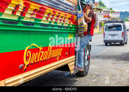 Street vendor entering a chicken bus | Los Encuentros | Guatemala Stock Photo