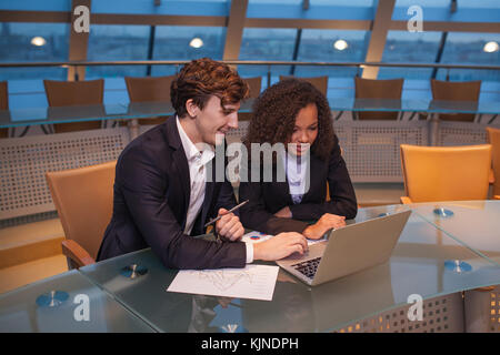 Business people having meeting around table in modern office. Stock Photo