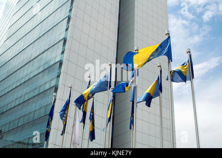 SARAJEVO, BOSNIA AND HERZEGOVINA - JUNE 5, 2008: Flag of Bosnia waiving in front of the Parliament of Bosnia and Herzegovina, one of the symbols of th Stock Photo