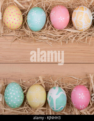 Border of Easter eggs on wood background Stock Photo