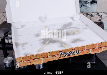 Empty pizza box with grease stains, a  fast food concept Stock Photo