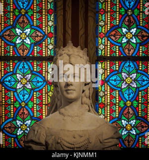 Bust statue of Princess Elisabeth of Austria (aka Sisi) with decorated stained glass windows on the background in the Matthias Church in Budapest. Stock Photo