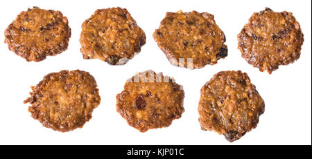Yummy baked flat cookies made of honey, nuts and raisins. Collection of round biscuits with chocolate coating underneath. Isolated on white background Stock Photo