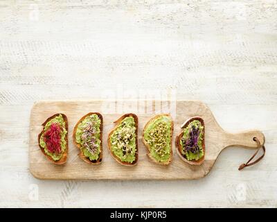 Bruschetta on a wooden chopping board. Stock Photo