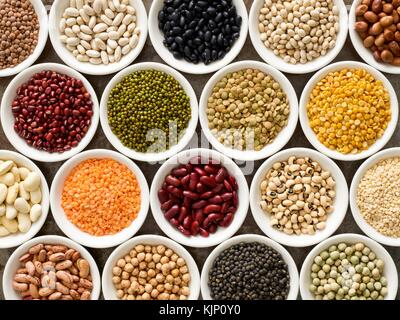 Pulses in white bowls, overhead view. Stock Photo